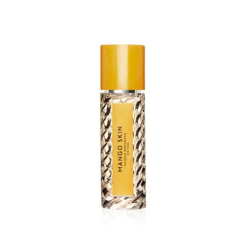 A travel size perfume bottle with a  yellow cap, label and black lettering.