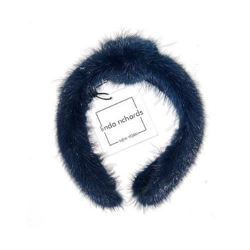 A navy mink fur headband with a knot in the middle. The label has black text that reads “linda richards NEW YORK.” 