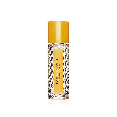 A travel size perfume bottle with a  yellow cap, label and black lettering.