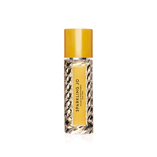 A travel size perfume bottle. The glass bottle features a textured design with a clear center where the label is visible. The bottle’s cap is a yellow color.